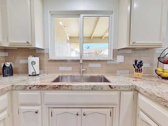 Over sized Stainless steel sink looking out to the beautiful backyard