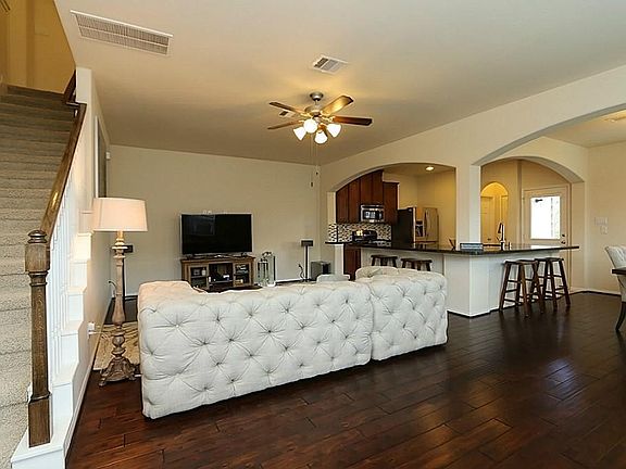 The living room is spacious with a clean, contemporary feel & the entry foyer is truly welcoming. The floor plan is great for entertaining with an open design. The wood floors are a gorgeous highlight of this quality townhome.