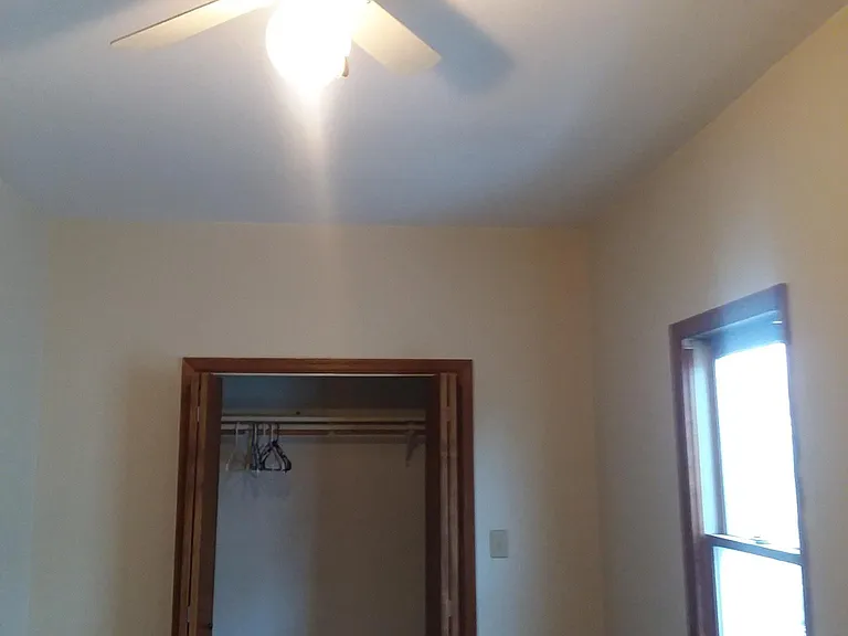 Master Bedroom with Carpet and ceiling fan, looking to closet