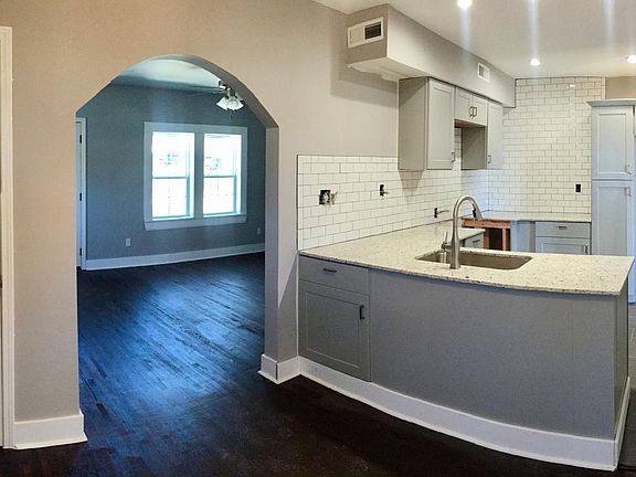 Open kitchen with new tile, granite countertops. Original ha