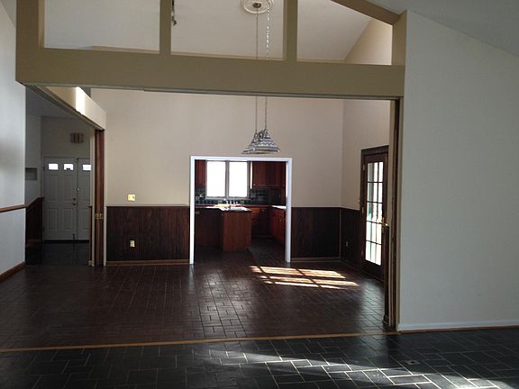 Living room/dining room/kitchen. Entrance to a deck off dining room.