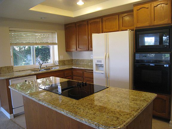 Kitchen. Cabinets will be refinished or painted white prior 