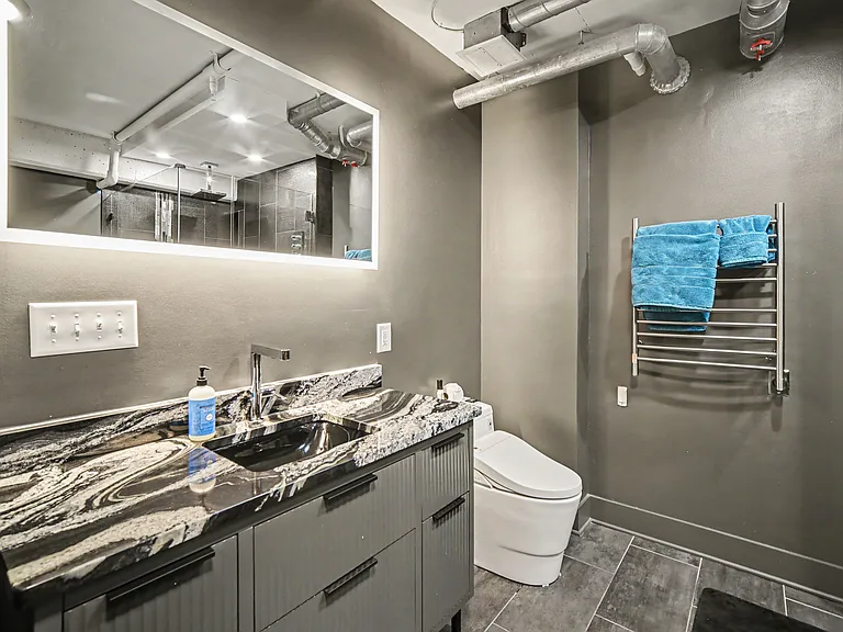 Master bathrooms features soak in bathtub with jets, massive shower with rain head and 2 additional wall shower heads and handheld shower head, backlit mirror, towel warmer, and bidet