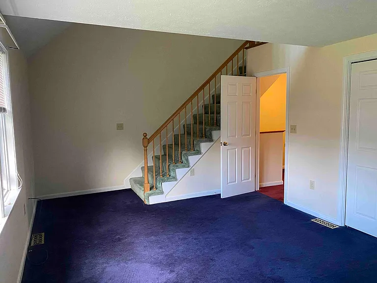 Primary bedroom with stairs to loft