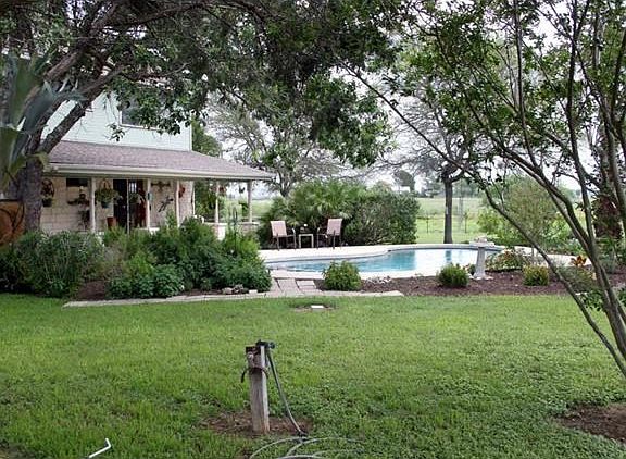 Beautifully manicured backyard with in ground pool