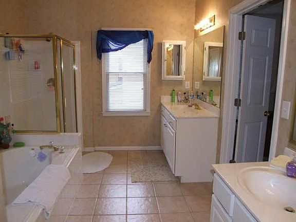 Master Bath, lots of tile, separate shower & garden tub.