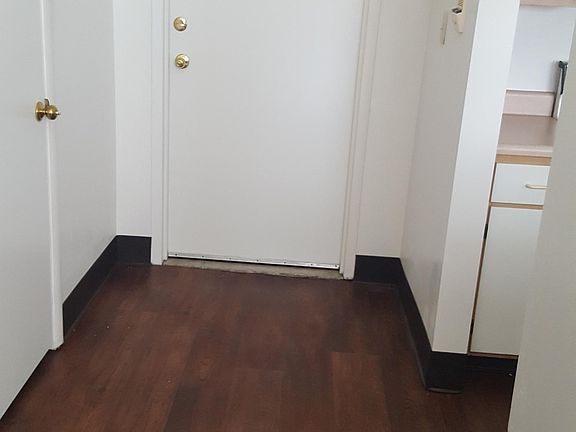 entry- coat closet (left), kitchen (right)