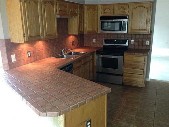Kitchen with Oak Cabinets and tiled countertops