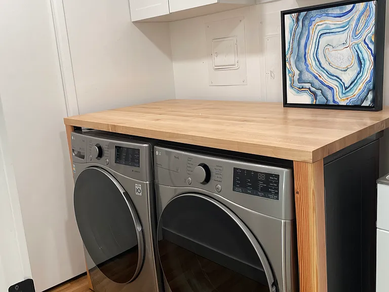 Functional Laundry with a place to fold.
Tons of storage cabinets on the top.