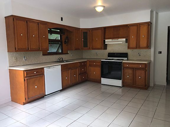 Huge eat-in-kitchen with new tile floor.