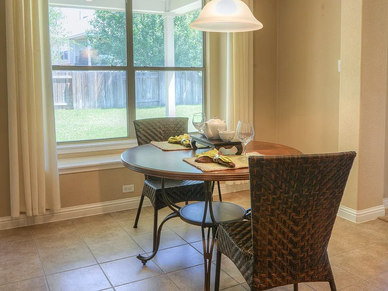 Breakfast area is connected to kitchen and looks into back yard patio