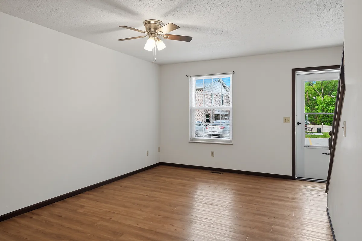 Big living room with luxury vinyl plank flooring the main floor. Newer windows and lots of ceiling fans. - 1498 Dartmouth Dr #1498