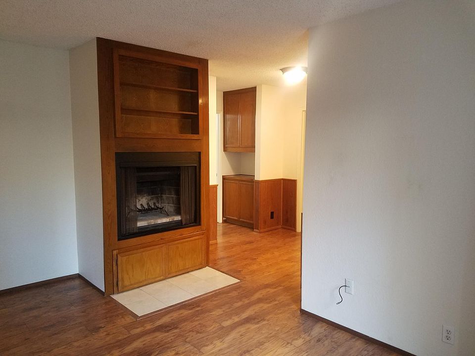 living room/dining room with fireplace and wood bookshelves