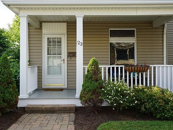 New sidewalk will lead to the covered front porch with newer railings and updated ceiling.