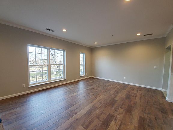 Open living space with plenty of room with a sectional, or sofa and love seat plus dining space. Brand new hardwood floors throughout. Neutral and clean.
