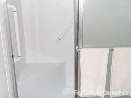 Remodeled bath with step in shower