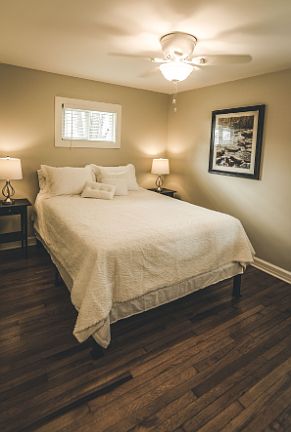 Bright, comfortable bedroom with hardwood floors, soft lighting, and a clean, well-maintained setup_ideal for extended stays for relocation clients, traveling professionals, and month-to-month renters seeking comfort and convenience.