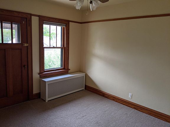 Bedroom 1, with access to small porch overlooking back yard.