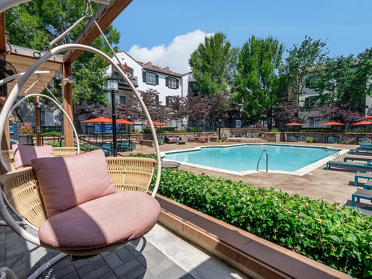 Relaxing Pool Area Featuring Poolside Swings and Ample Seating Options