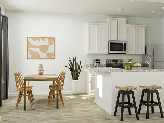 The chef-ready kitchen offers plenty of storage in the stunning white cabinets and walk-in pantry.