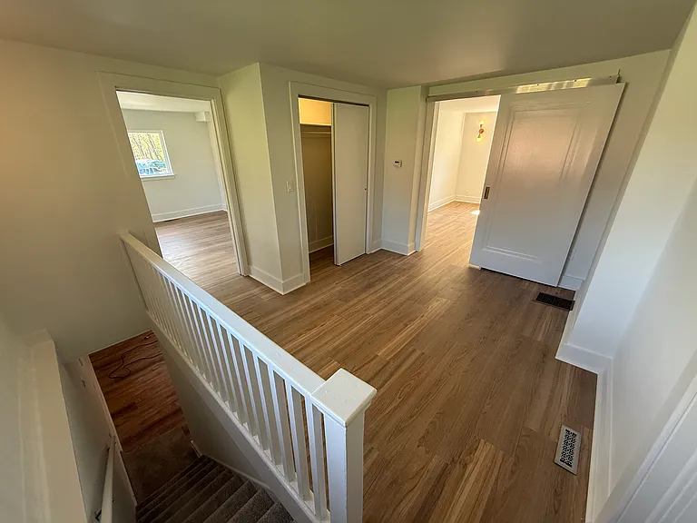 Sitting room at top of stairs with closet and bathroom connected