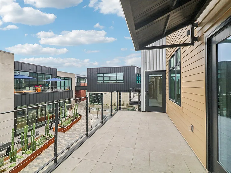 Large balcony overlooking landscaped courtyard