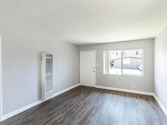 Living area with access to patio, and 1 of 2 entrances to unit.
