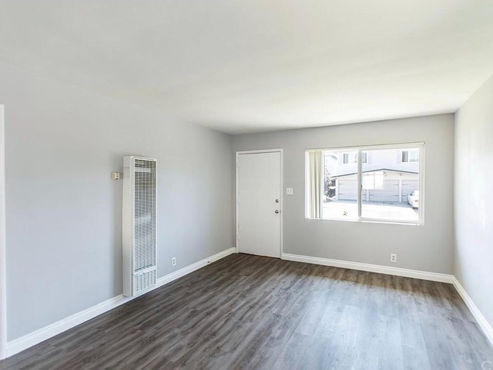 Living area with access to patio, and 1 of 2 entrances to unit.