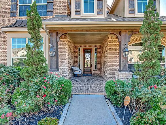 Walk up to your front porch and notice the 8' Mahogany Front Door with an Iron Grill.