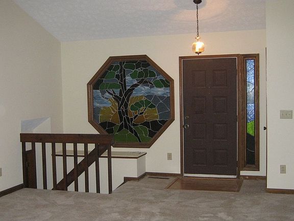 THIS STAINED GLASS WINDOW STAYS WITH THE HOME AND WAS CUSTOM MADE FOR THIS SPOT