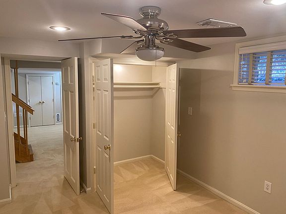 1st bedroom with ceiling fan, large closet and 3 windows