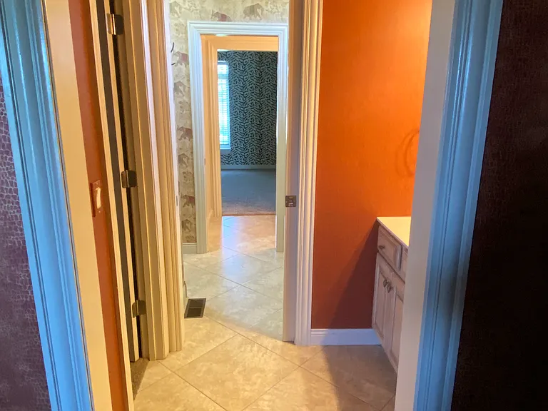 Looking from second bedroom through the Jack and Jill bathroom to the third bedroom. Pocket doors in between.