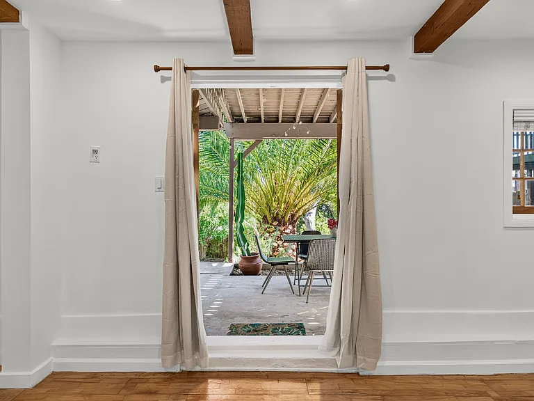 French doors w/ blackout curtains that open to private covered patio