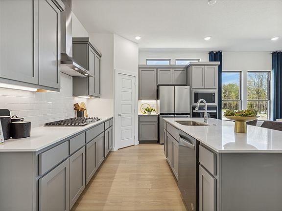 Kitchen in the Van Gogh II home plan by Trophy Signature Homes - REPRESENTATIVE PHOTO