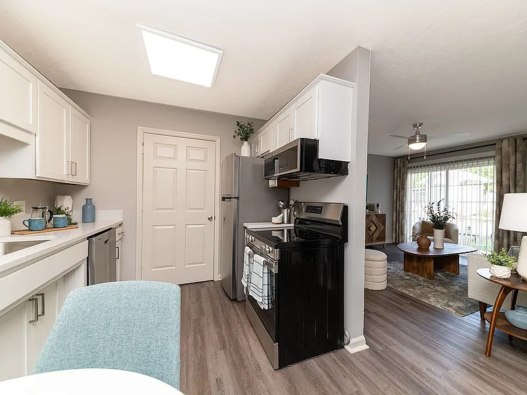 Kitchen and dining area with hardwood-style flooring
