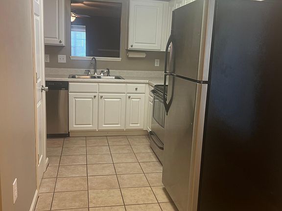 Kitchen view from dinning area, contains pantry, refrigerator