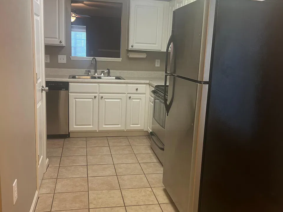 Kitchen view from dinning area, contains pantry, refrigerator