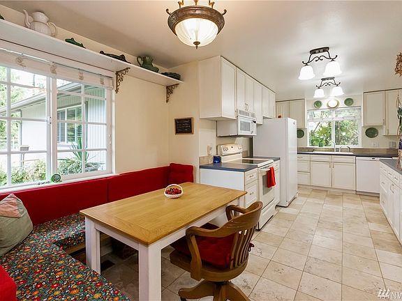 Eat in area,  shelving and tile flooring makes this large kitchen extremely functional.
