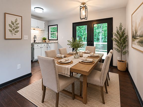 Kitchen, dining area, and access to the deck from main floor along with 2 bedrooms and bath