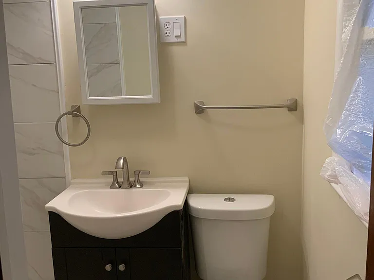 Shower, bathroom on backside beside family room with window to the backyard