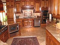 Gourmet kitchen with stainless steel appliances and large island overlooking f