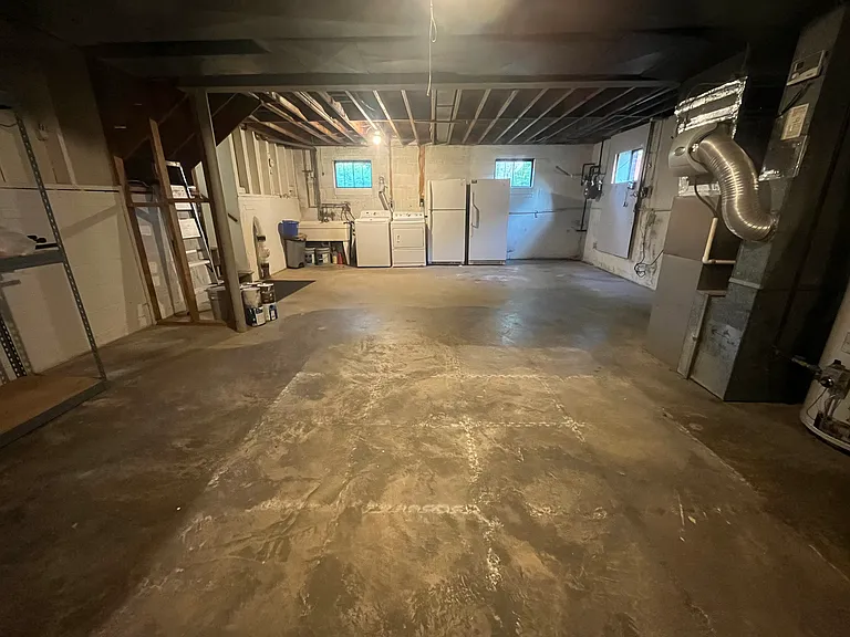 Unfinished basement - laundry, extra refrigerator & freezer, utility room, ample storage with shelves
