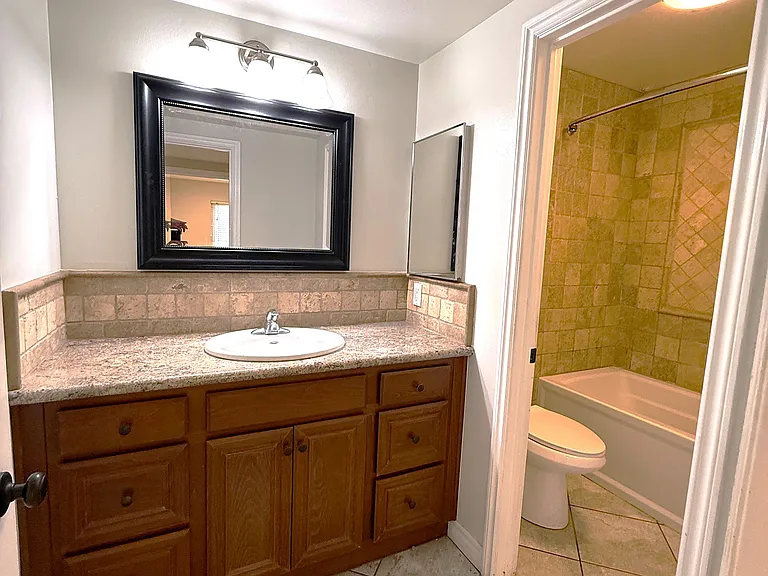 Downstairs bath by the two bedrooms.