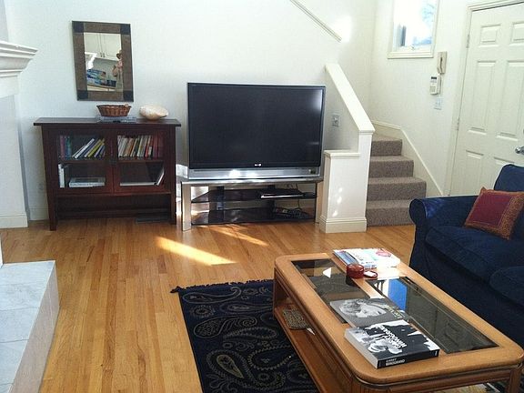 Living room facing monitor with Apple TV and DVD player, int