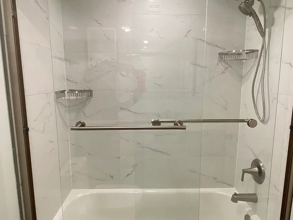 New tub, glass enclosure, shower fixtures.