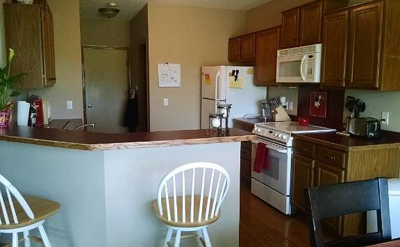Main floor kitchen with a wrap around breakfast bar.