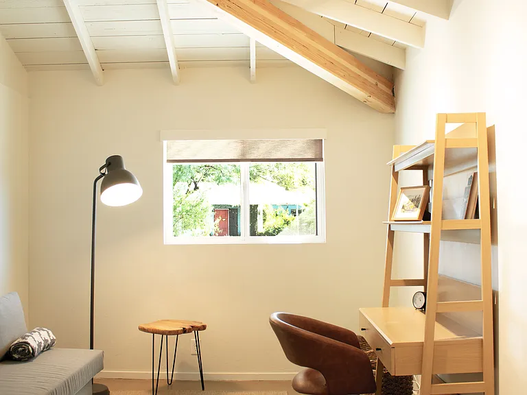 Dedicated office/workspace with desk and natural light.