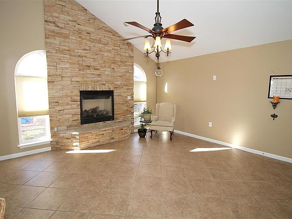 Hearth room with stone floor to ceiling gas fireplace.