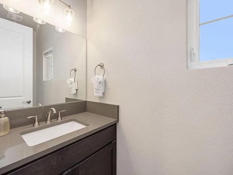 Powder room on main level - located next to the garage entry and laundry room