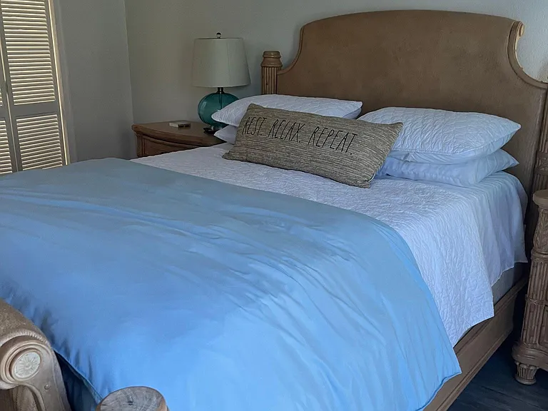 Queen size bed in master bedroom.